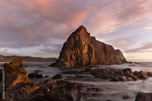 sunset view of lion rock at south cape bay in the wilderness of south west national park