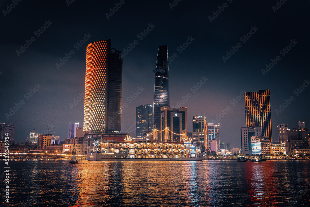 Obraz premium view of Bitexco and IFC One Tower, buildings, roads and Saigon river in Ho Chi Minh city - Laser and lighting show displayed. Travel and landscape concept.