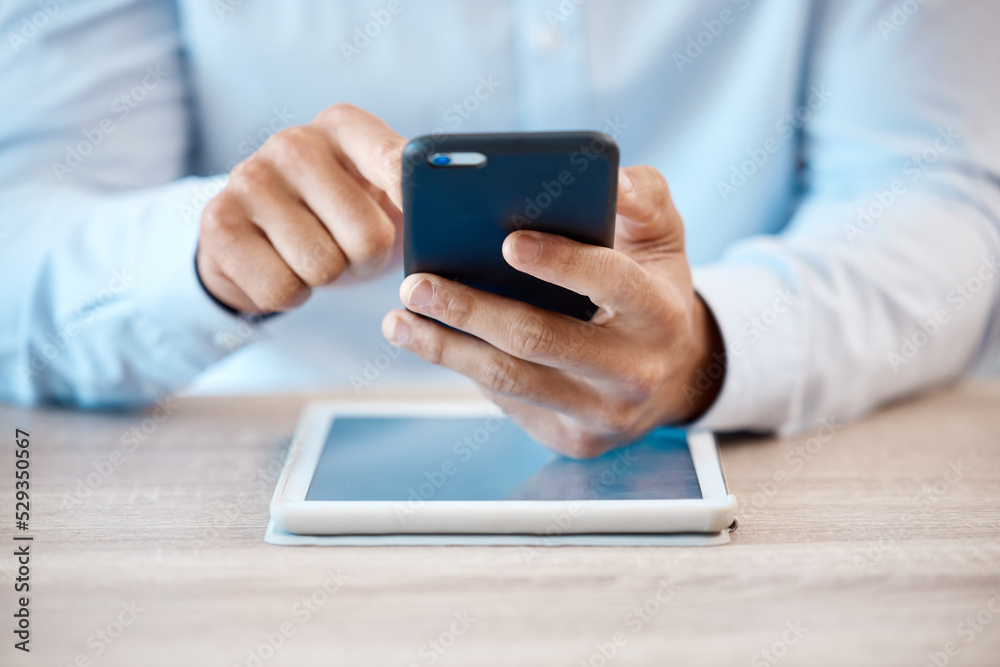 Internet, technology and communication, a man with phone in hand and tablet on desk. Businessman online in contact with client, reading email or browsing social media. Fintech, ux and payment via app Internet, technology and communication, a man with phone in hand and tablet on desk. Businessman online in contact with client, reading email or browsing social media. Fintech, ux and payment via app