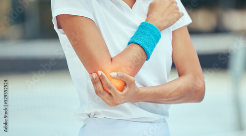 Tennis elbow, pain and injury with a sports woman holding her joint during training, workout and exercise. Fitness, health and accident with a female athlete in a game or match on a court outside