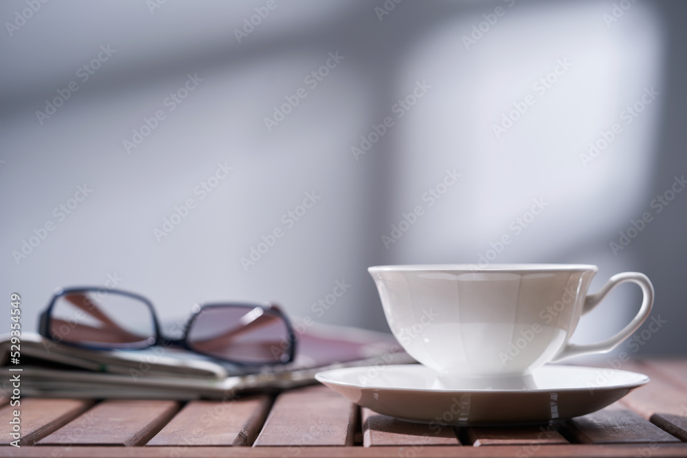 coffee cup newspaper and reading glasses