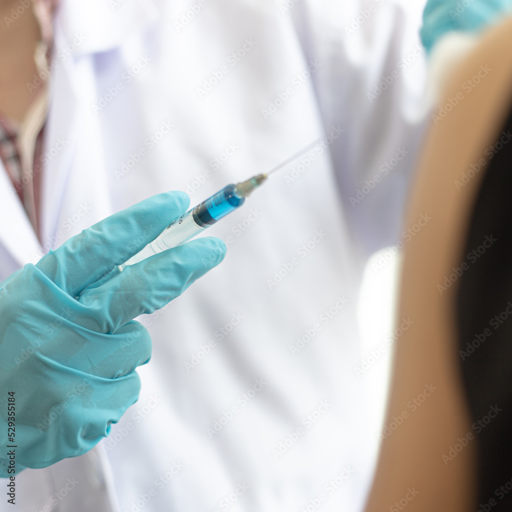 Doctor is vaccinating women with antibiotics or new antibodies to prevent the spread of the virus, Vaccination against communicable diseases concept. Doctor is vaccinating women with antibiotics or new antibodies to prevent the spread of the virus, Vaccination against communicable diseases concept.