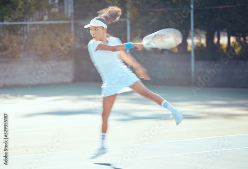 Tennis, action and active woman athlete playing sports, fitness and workout on game court. Training, motion and professional tennis player using racket to hit ball in competition match