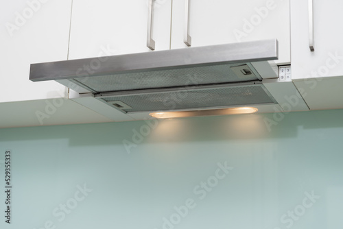 Bilde på lerret A clean range hood in the kitchen.
