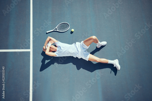 Fototapeta Naklejka Na Ścianę i Meble -  Tired tennis sports loser man on floor with racket, ball and court in summer sun from above. Relax and fitness player lying on ground, resting or taking break after match, game or outdoor practice