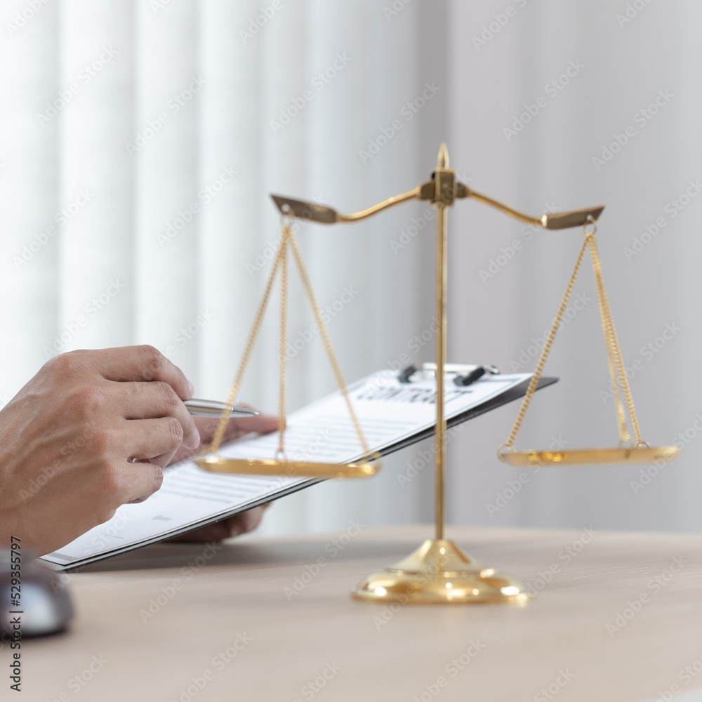 Judge or a lawyer works documents in the courtroom and analyze the various laws for justice and accuracy, Litigation and justice concept. Judge or a lawyer works documents in the courtroom and analyze the various laws for justice and accuracy, Litigation and justice concept.