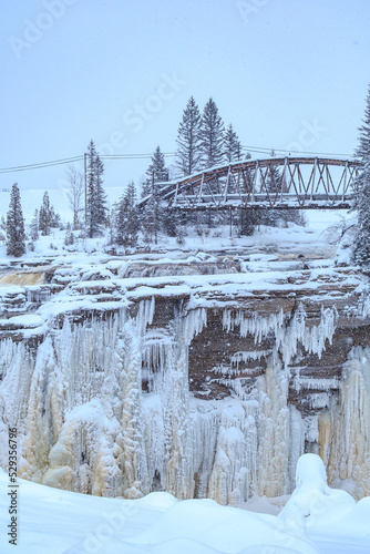 View on the frozen waterfall of Chute-Aux-Galets on a snowy winter day near Saguenay, Quebec (Canada) © Pernelle Voyage