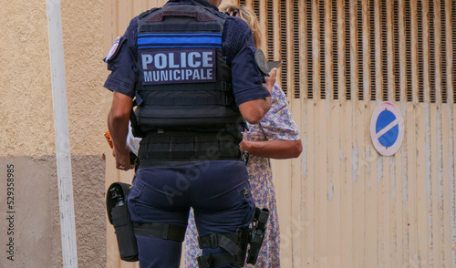 Fototapeta Naklejka Na Ścianę i Meble -  back view of french police man standing in the street