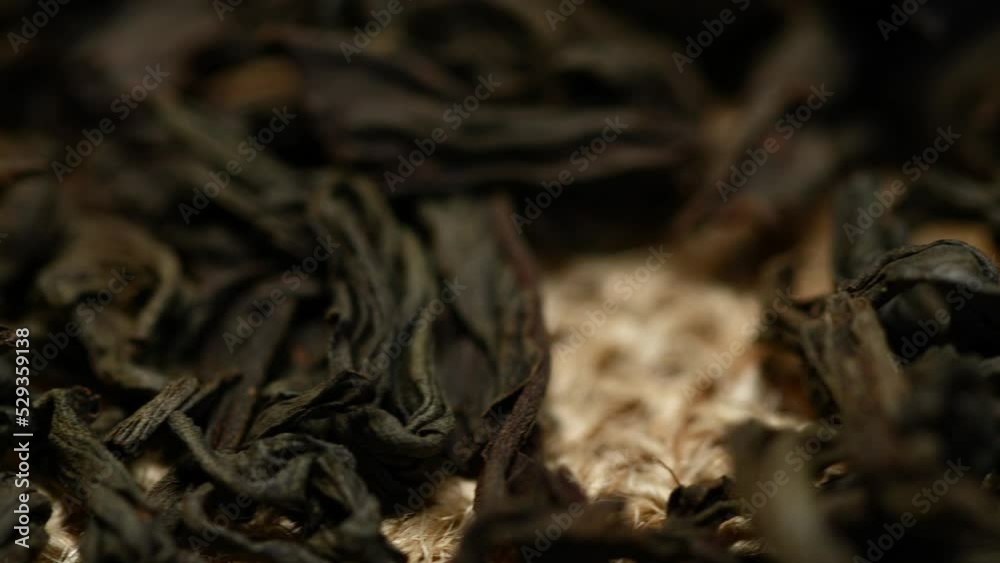 Close-up herbal black or green tea leaves texture on jute sack, food background Close-up herbal black or green tea leaves texture on jute sack, food background