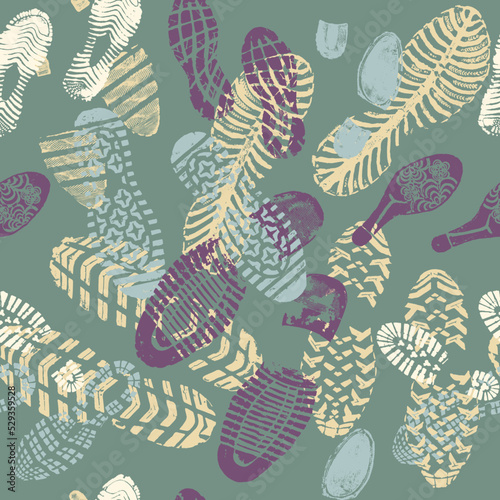Vector seamless pattern color images double footprints yellow violet blue on green background