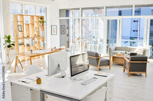 Empty office room, workplace or interior with an arranged desk, computers and furniture. Corporate organized work space, business company working area or modern headquarters workspace