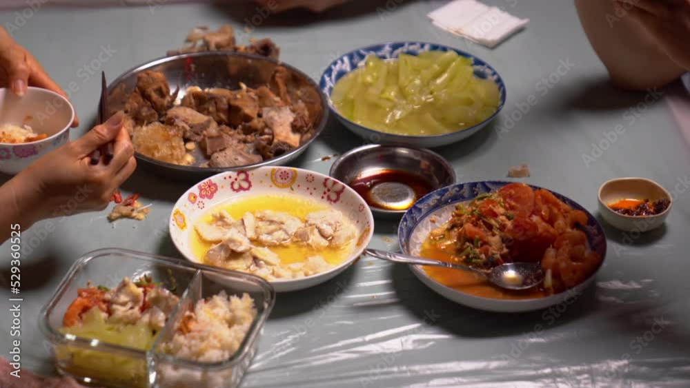 eating with chopsticks on a white table. two Asian man eating a meal. Chinese and East Asian eating traditions. enjoys eating chinese food.