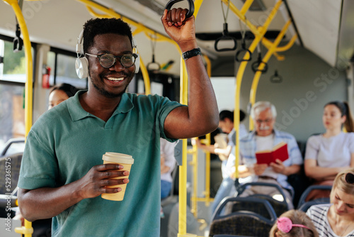 Print op canvas Black man having coffee to go in bus