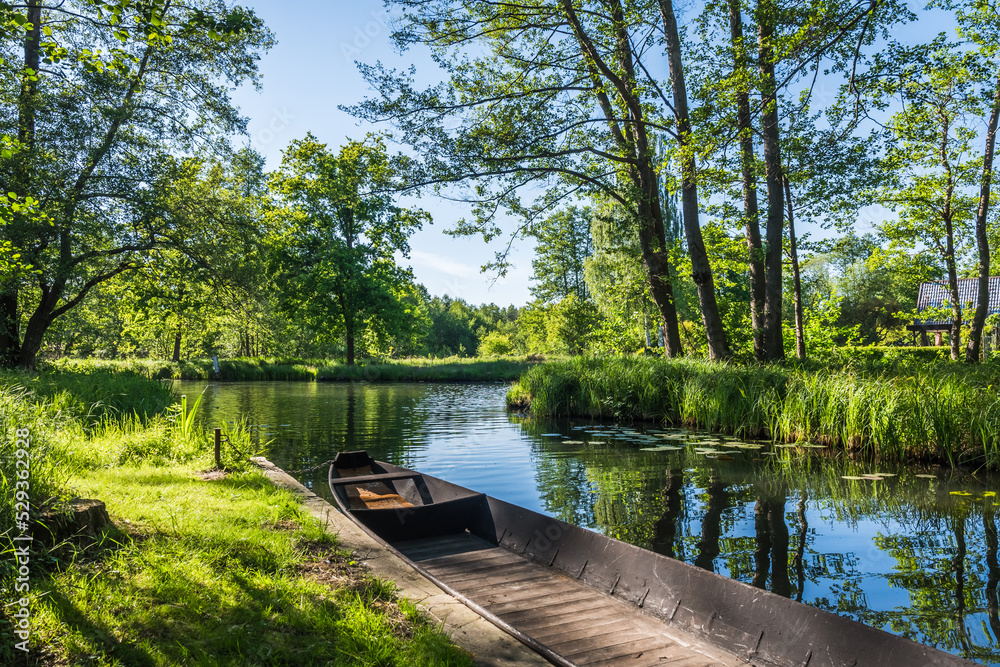 Water channel in the Spreewald Biosphere Reserve in Germany, with one of the typical wooden boats. Water channel in the Spreewald Biosphere Reserve in Germany, with one of the typical wooden boats.