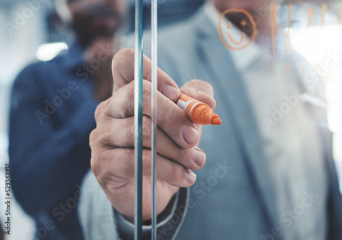 Project manager hand planning a strategy or writing notes on a glass. Businessman brainstorming and thinking of ideas in his presentation. Corporate male entrepreneur being innovative in an office