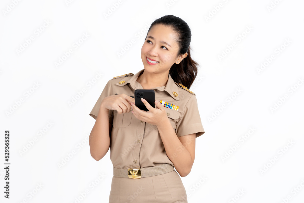 Portrait of Young asian Thai female teacher in uniform is using mobile phone and feeling surprised isolated over white background Portrait of Young asian Thai female teacher in uniform is using mobile phone and feeling surprised isolated over white background