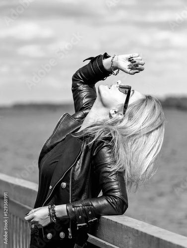 A young woman in leather jacket. Concept of grunge style 90x, mix clothes, outfits for women photo