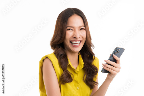 Asian woman long hair wear green shirt is holding a smartphone with a smile. isolated on white background.