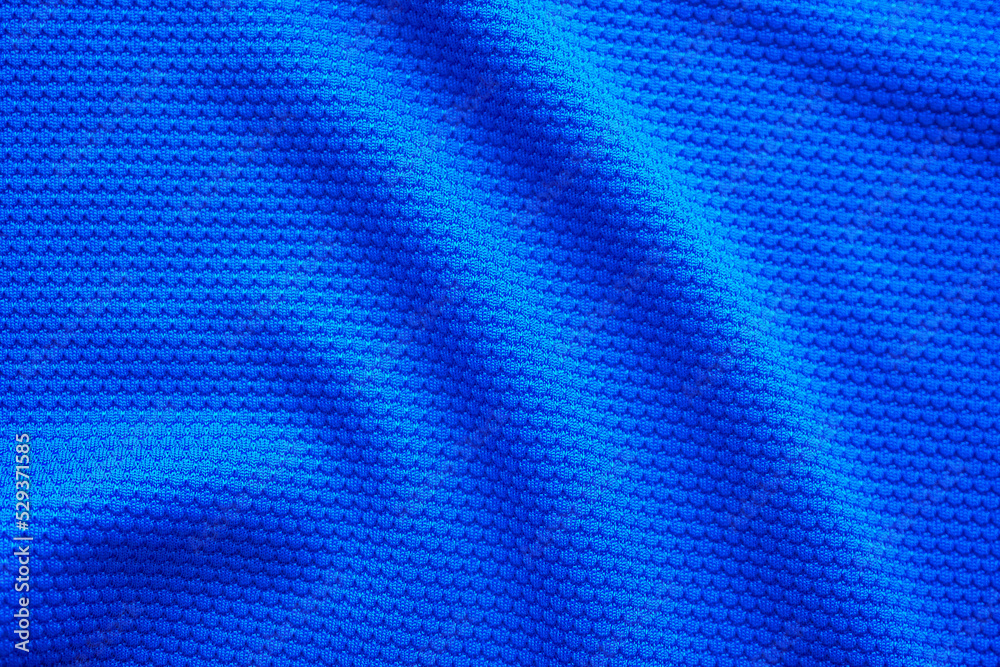 Blue football jersey clothing fabric texture sports wear background, close up top view Blue football jersey clothing fabric texture sports wear background, close up top view