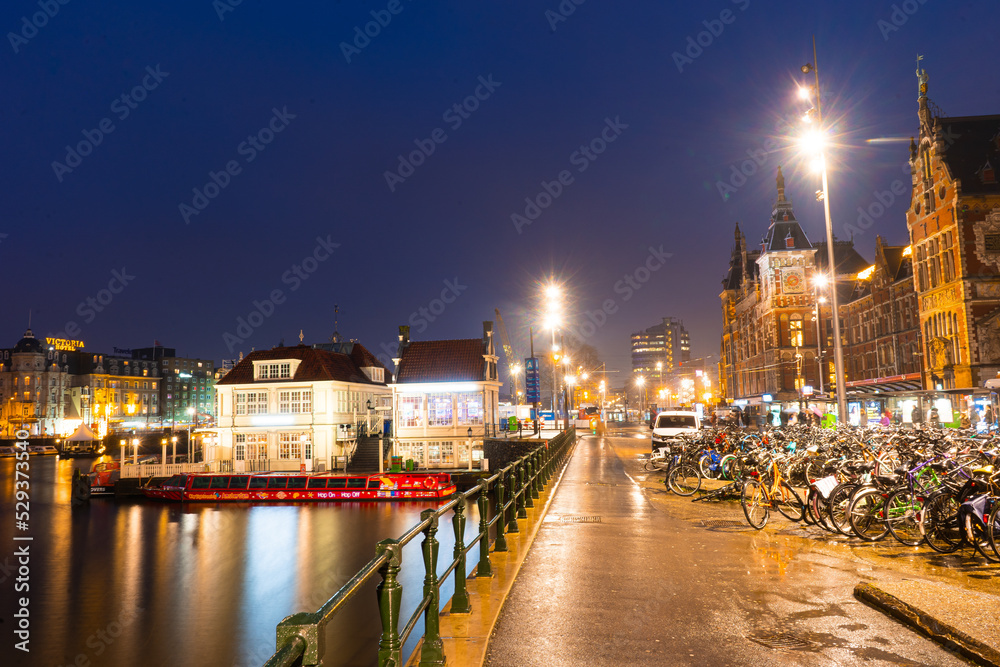 Amsterdam train station during early morning before sunrise , Amsterdam , Netherlands : November 27 , 2019 Amsterdam train station during early morning before sunrise , Amsterdam , Netherlands : November 27 , 2019