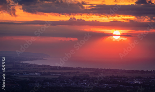 Brilliant September sunrise from Butts Brow looking east along the coast to Hastings East Sussex south east England UK