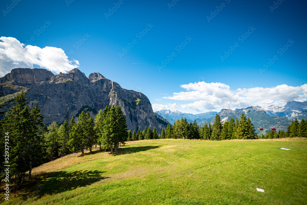 landscape with clouds over the mountains dolomiti monte Pelmo, with blue sky and green trees in Italy