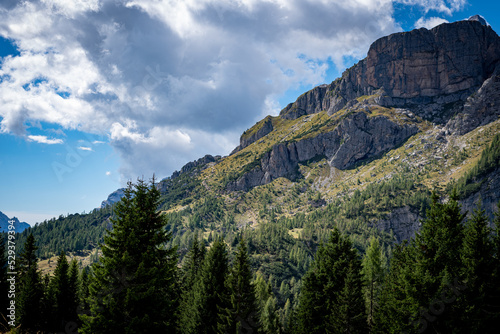 landscape with clouds over the mountains dolomiti monte Pelmo  with blue sky and green trees in Italy