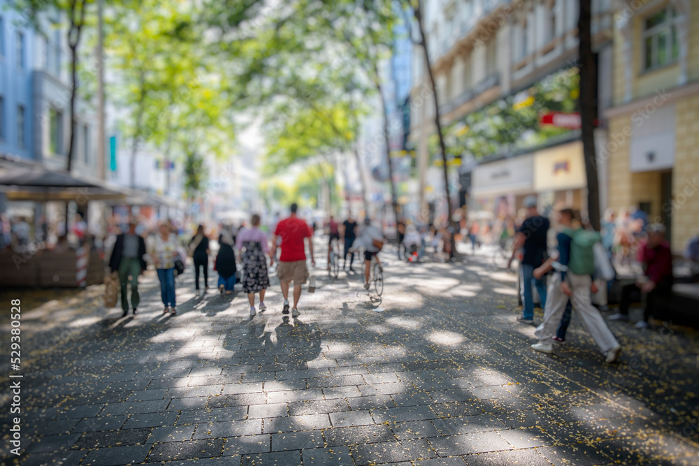 Crowd of anonymous people walking busy street