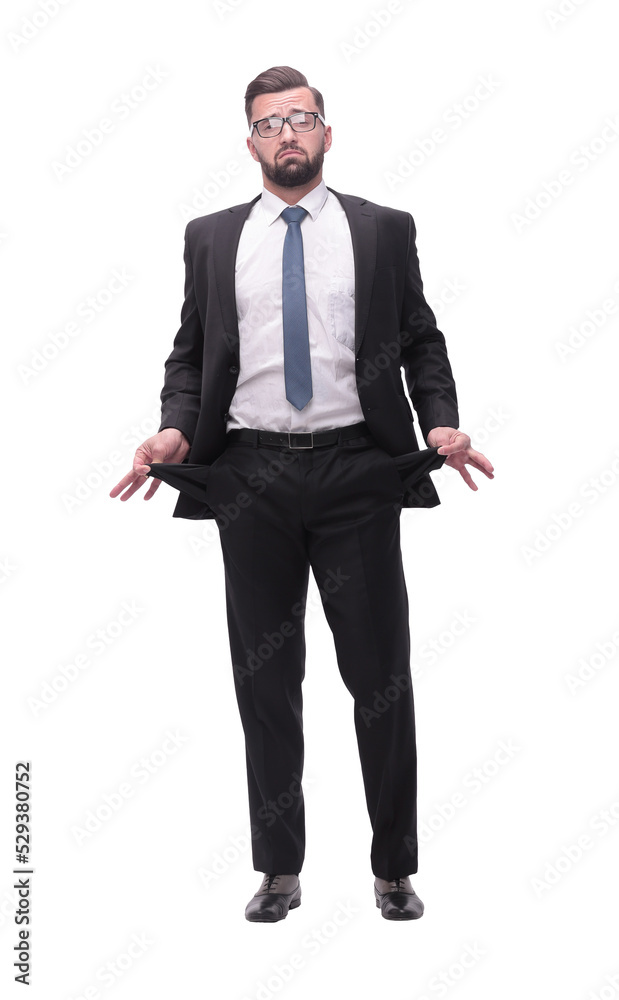 in full growth. frustrated businessman showing his empty pockets in full growth. frustrated businessman showing his empty pockets