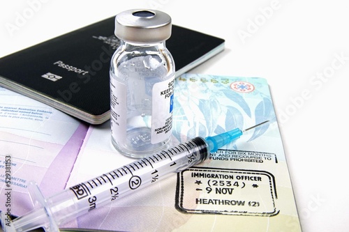 medical vaccination equipment and australian passports with immigration stamp on a white background 