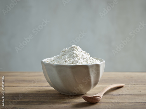 bowl of flour on wooden kitchen table