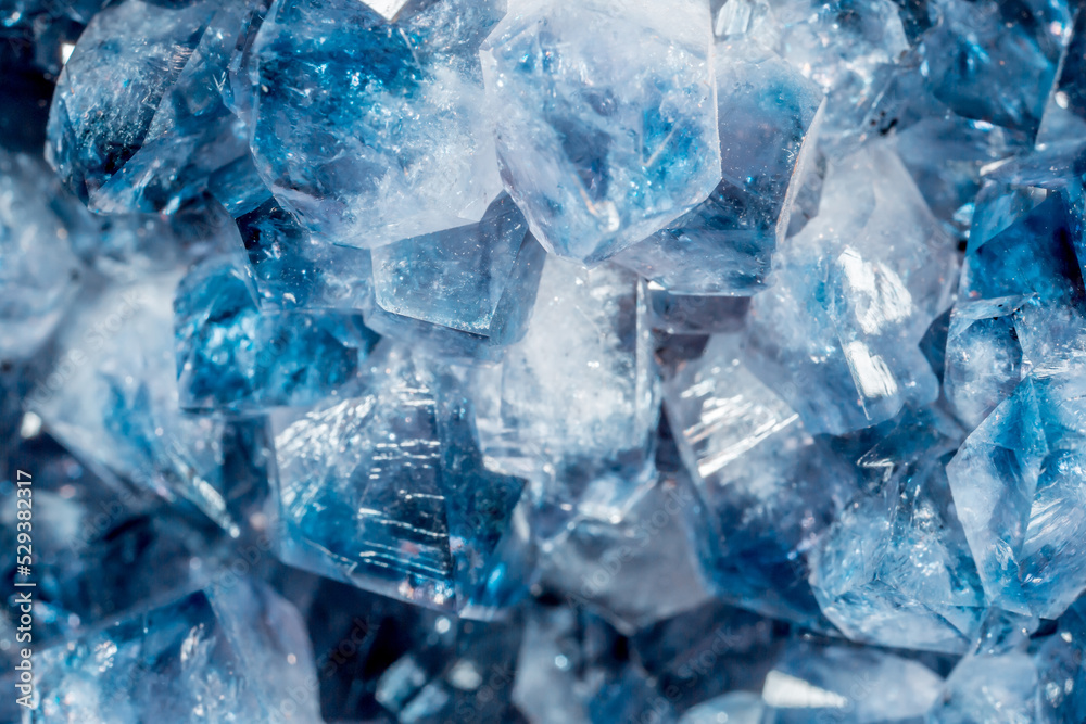 Blue Crystal Mineral Stone. Gems. Mineral crystals in the natural environment. Texture of precious and semiprecious stones. Seamless background with copy space colored shiny surface of precious stones