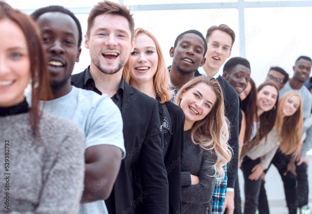 close-up . young woman standing in front of a group of young people close-up . young woman standing in front of a group of young people