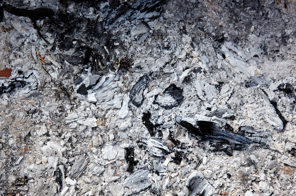Smoldering charcoal in a barbecue. Scattered pieces of embers in the hearth mixed with ash. Ashes after to prepare food outdoor Smoldering charcoal in a barbecue. Scattered pieces of embers in the hearth mixed with ash. Ashes after to prepare food outdoor