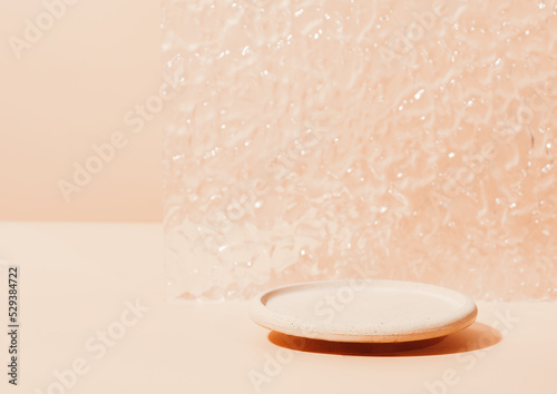 Minimal modern product display on neutral beige background. round concrete podium and glass door. Concept scene stage showcase for new product, promotion sale, presentation.