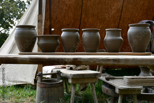 Photography A close up on a set of colorful clay pots, bowls, and other containers standing