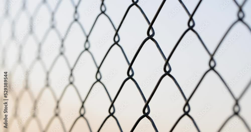 Fencing from a galvanized chain-link mesh, shallow focus Fencing from a galvanized chain-link mesh, shallow focus