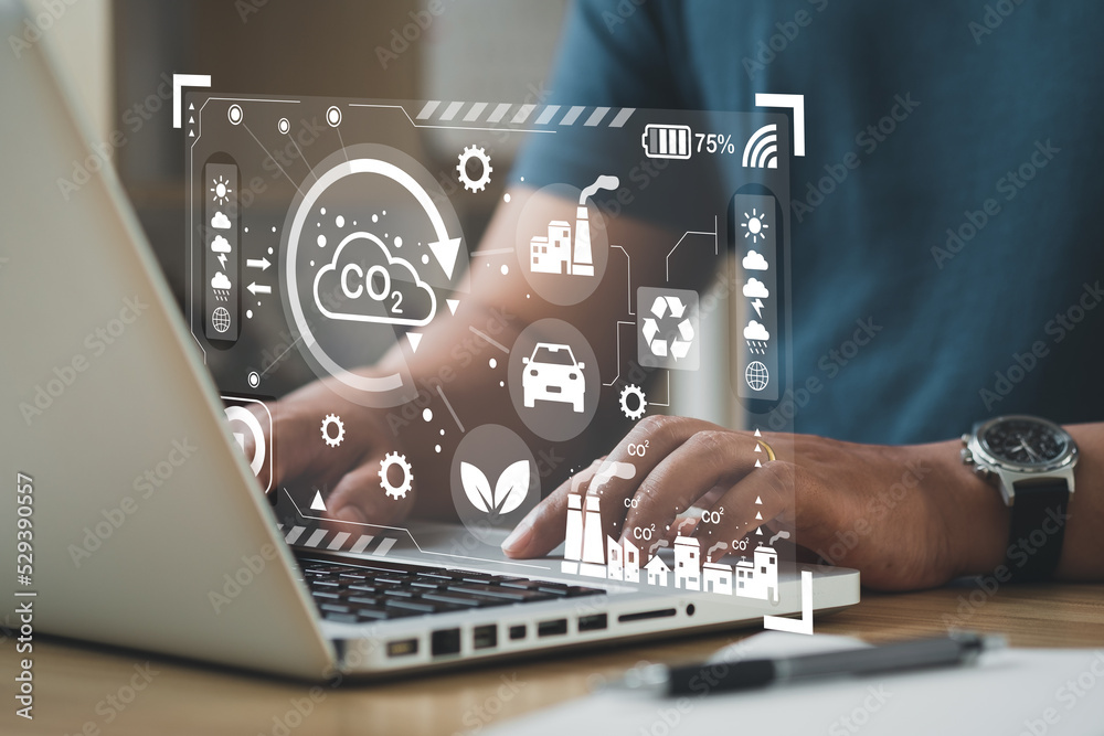 Fotografie Business man using computer on CO2 emission reduction concept with global warming icon