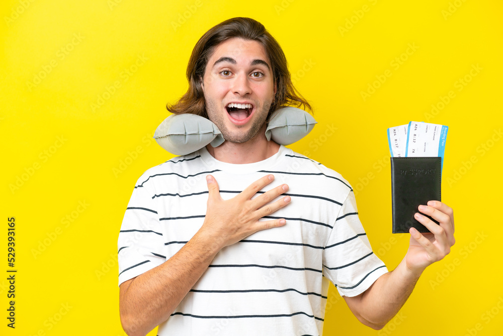 handsome Man with Inflatable Travel Pillow surprised and shocked while looking right handsome Man with Inflatable Travel Pillow surprised and shocked while looking right