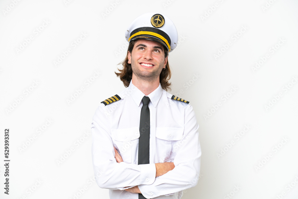handsome Airplane pilot isolated on white background looking up while smiling handsome Airplane pilot isolated on white background looking up while smiling
