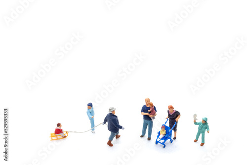 Miniature people Happy family ride a sleigh with white background, Christmas eve celebration concept.