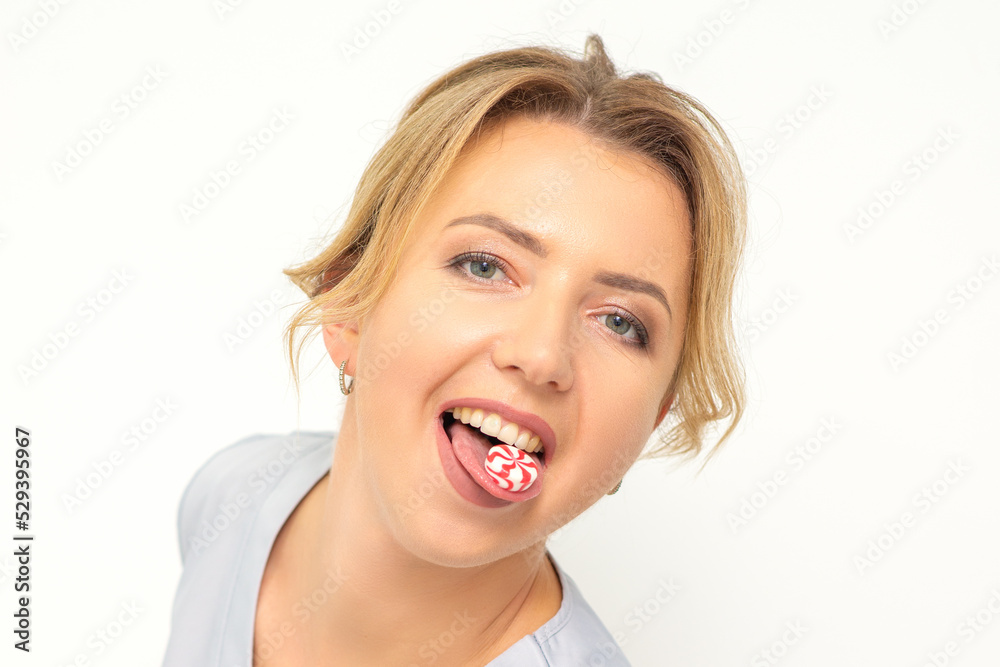 Waxing, depilation, hair removal concept. Happy young caucasian beautician with candy in her mouth looking at the camera on white background Waxing, depilation, hair removal concept. Happy young caucasian beautician with candy in her mouth looking at the camera on white background
