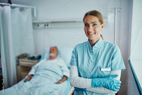 Obraz na plátne Happy confident nurse at recovery unit in hospital ward looking at camera