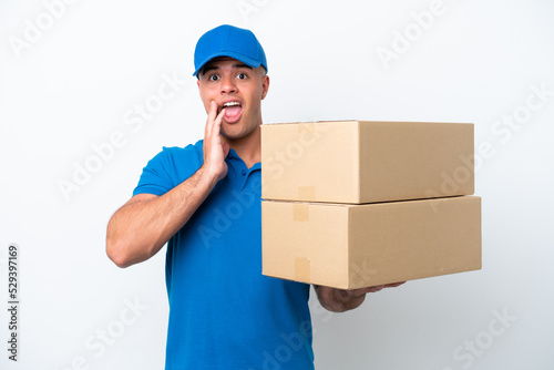 Delivery caucasian man isolated on white background with surprise and shocked facial expression © luismolinero