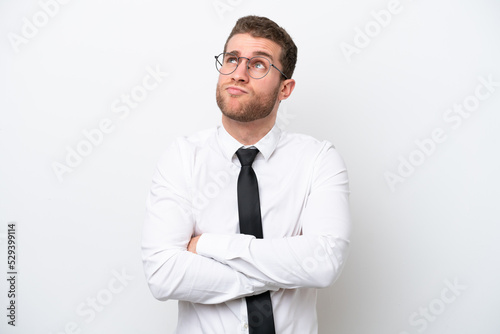 Young business caucasian man isolated on white background making doubts gesture while lifting the shoulders