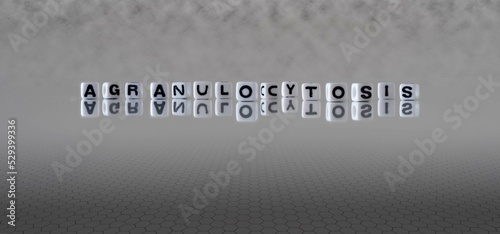 agranulocytosis word or concept represented by black and white letter cubes on a grey horizon background stretching to infinity