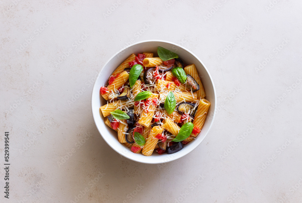 Pasta alla Norma with eggplant, tomatoes, cheese and basil. Italian food. Vegetarian food. Pasta alla Norma with eggplant, tomatoes, cheese and basil. Italian food. Vegetarian food.