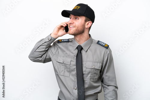Young safeguard caucasian man isolated on white background keeping a conversation with the mobile phone