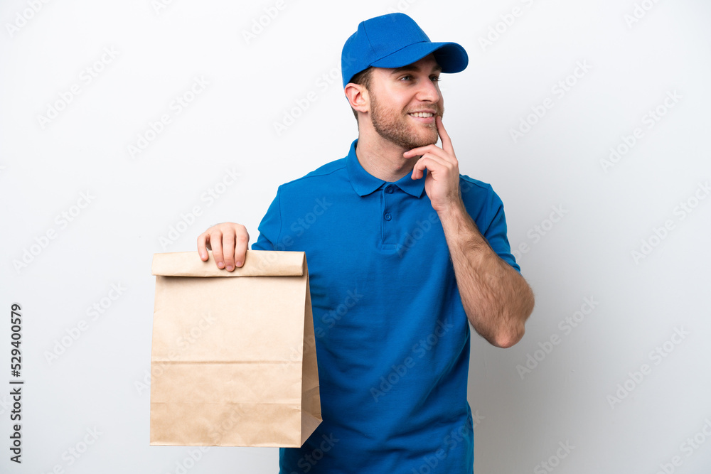 Delivery caucasian man isolated on white background thinking an idea while looking up Delivery caucasian man isolated on white background thinking an idea while looking up