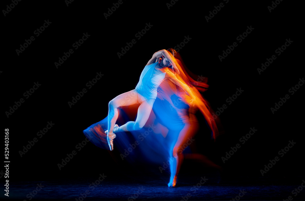 Dynamic portrait of tender slim girl, female ballet dancer in art performance isolated over black background in mixed bright neon light.